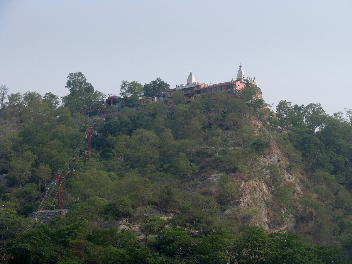 Mansa Devi Temple on top of Bilwa Parvat, Haridwar, with the ropeway climbing the wooded hill