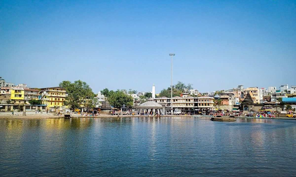 The Godavari at Gandhi Talav in Nashik, with ghats, temples and houses along the far bank