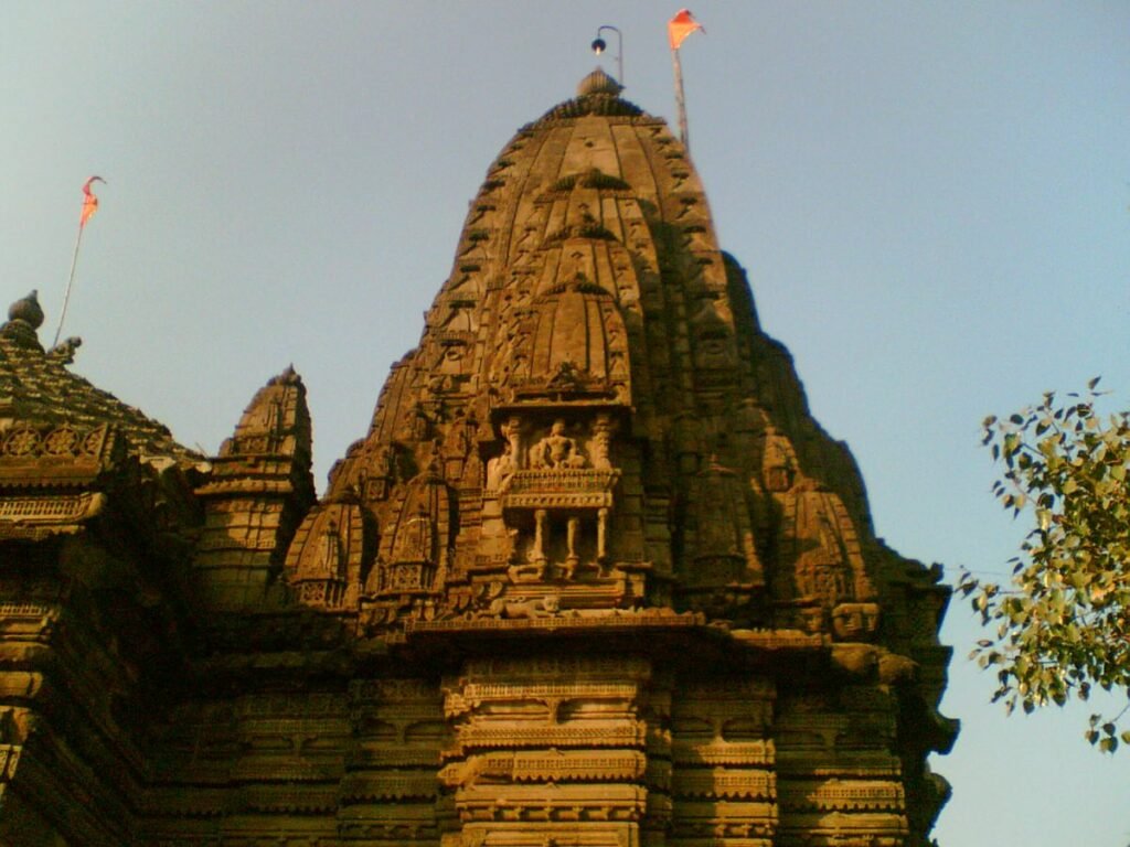 The carved stone shikhara of the Naroshankar Temple in Nashik, in warm light