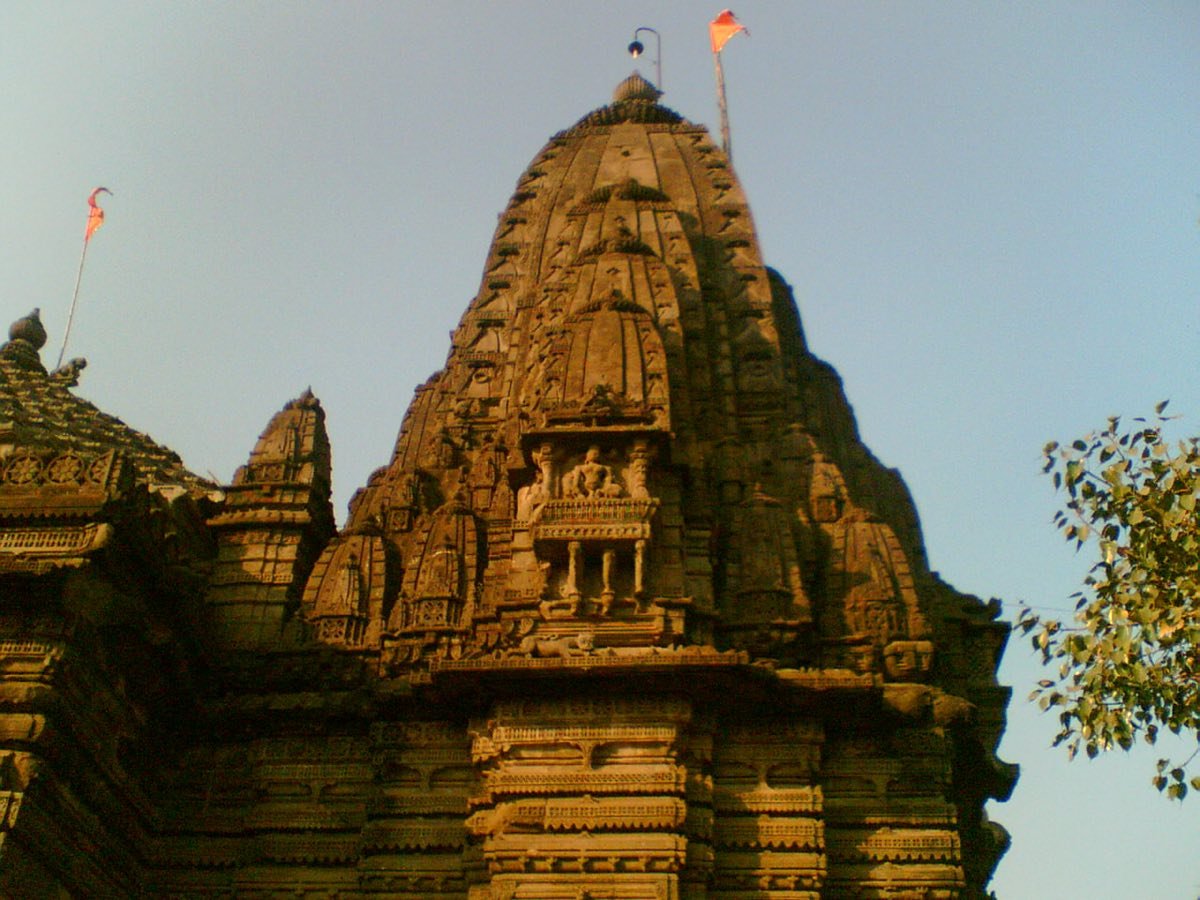 The carved stone shikhara of the Naroshankar Temple in Nashik, in warm light