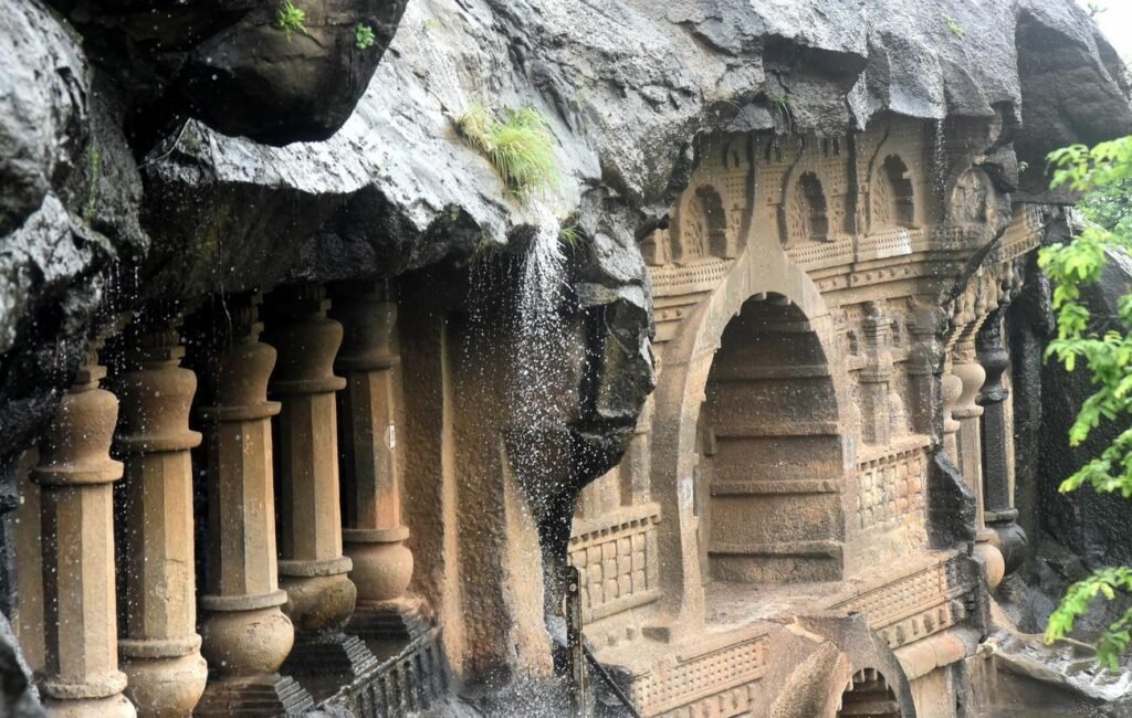 Carved pillars and an arched doorway cut into the rock at the Pandavleni Caves on Trirashmi hill, Nashik.