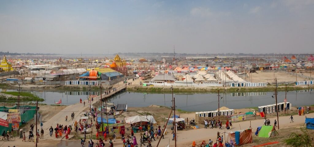 A wide view of the Kumbh Mela camps and a pontoon bridge over a river channel at Prayagraj in 2019