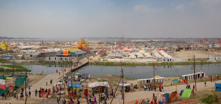 A wide view of the Kumbh Mela camps and a pontoon bridge over a river channel at Prayagraj in 2019