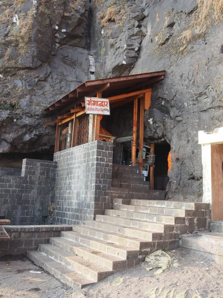 The Gangadwar shrine built into the rock face of Brahmagiri hill, with stone steps leading up to it