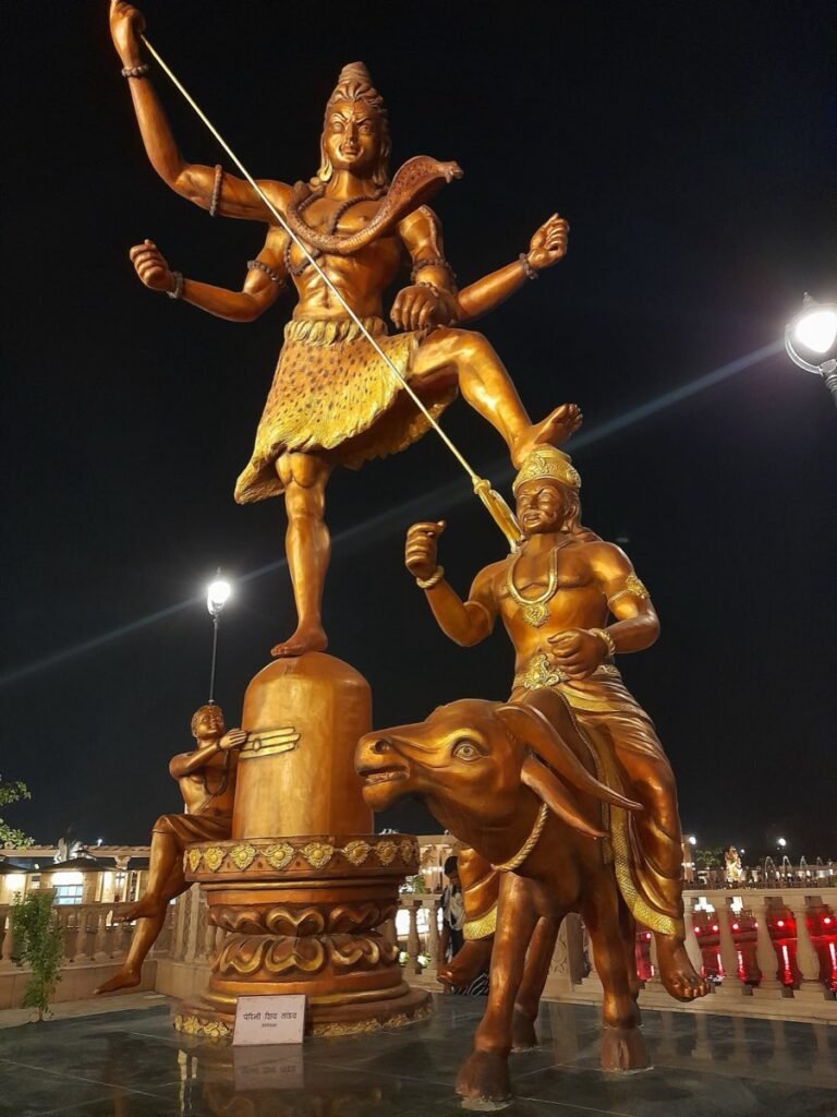 A gilded sculpture group in the Mahakal Lok corridor at Ujjain, lit up at night