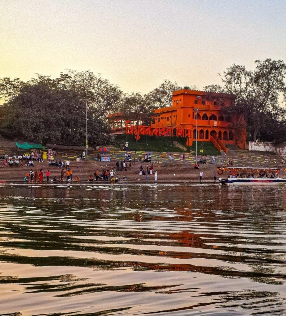 Evening light on the Shipra and the ghat steps at Ram Ghat, Ujjain, with a boat moored at the bank