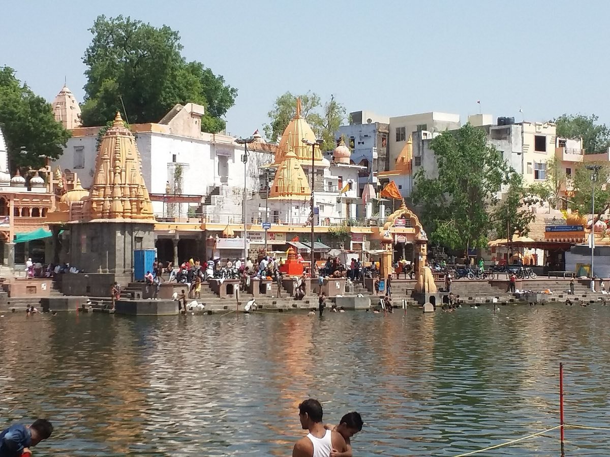 Temples and ghats along the Shipra river in Ujjain on a sunny day
